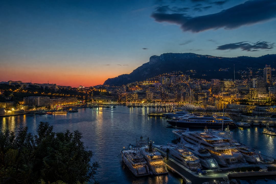 Mediterranean harbour with superyachts at blue hour