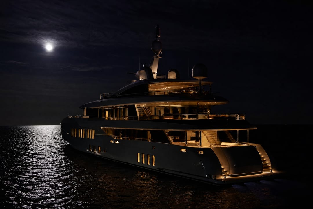 Superyacht at anchor at night on open sea